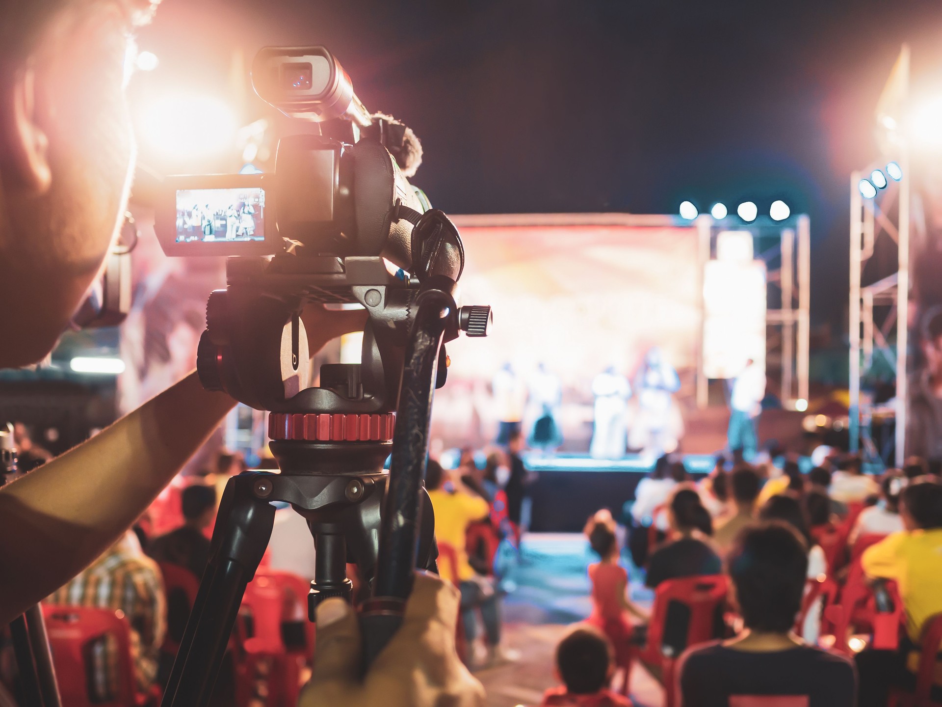 Professional digital camera recording video in music concert festival