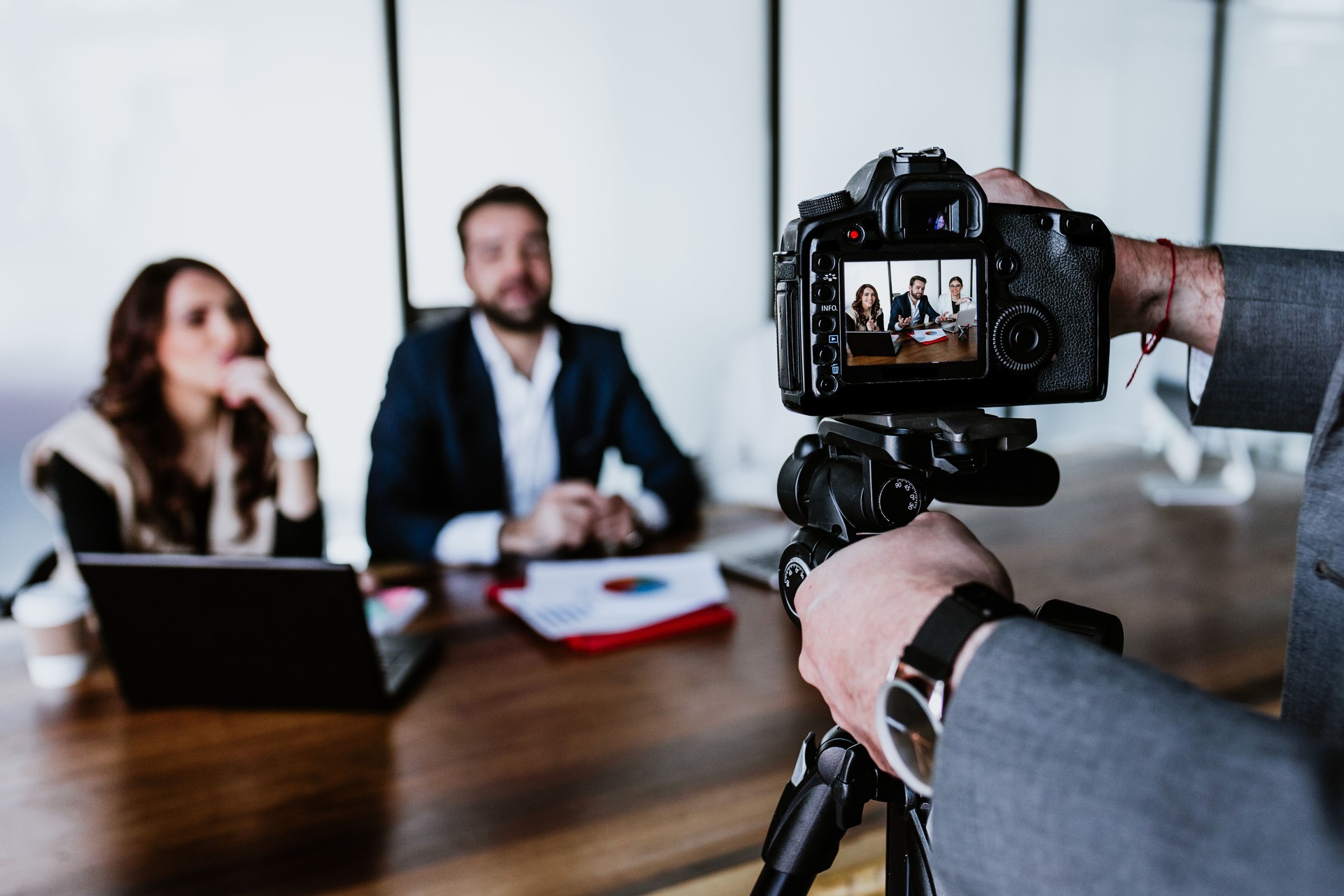 Hispanic Teamwork recording a video talk for social media with professional camera at the office in Mexico Latin America