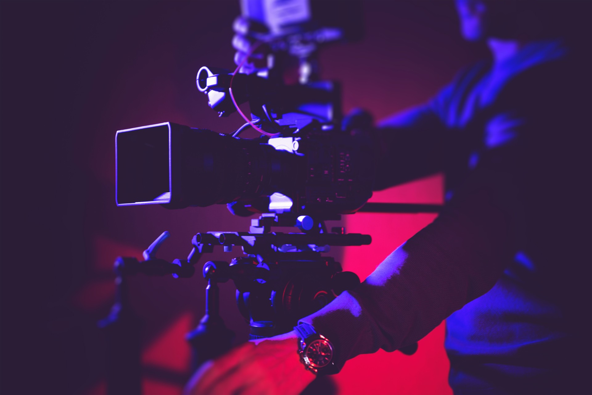 Camera Operator Adjusts Equipment During a Film Shoot in a Studio